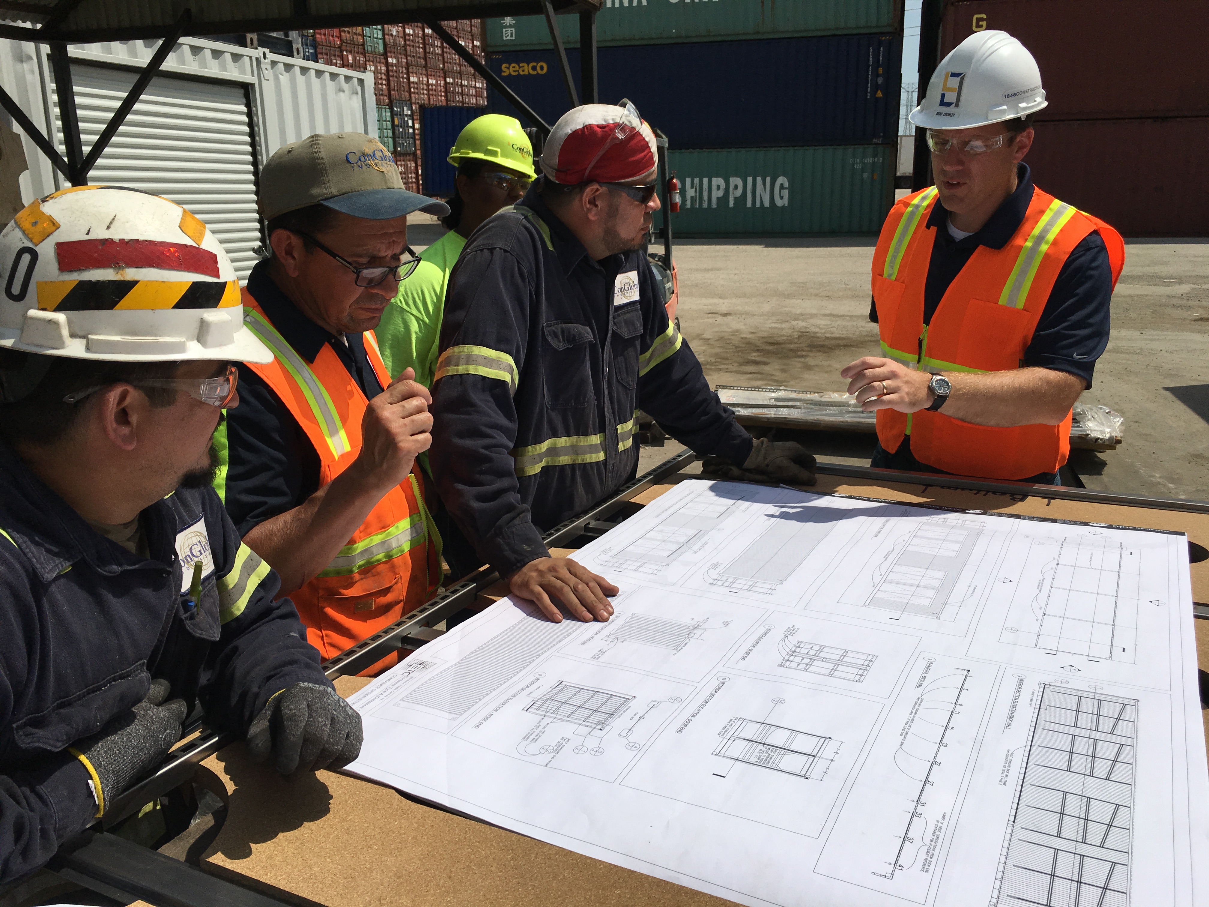 Construction workers looking at job site